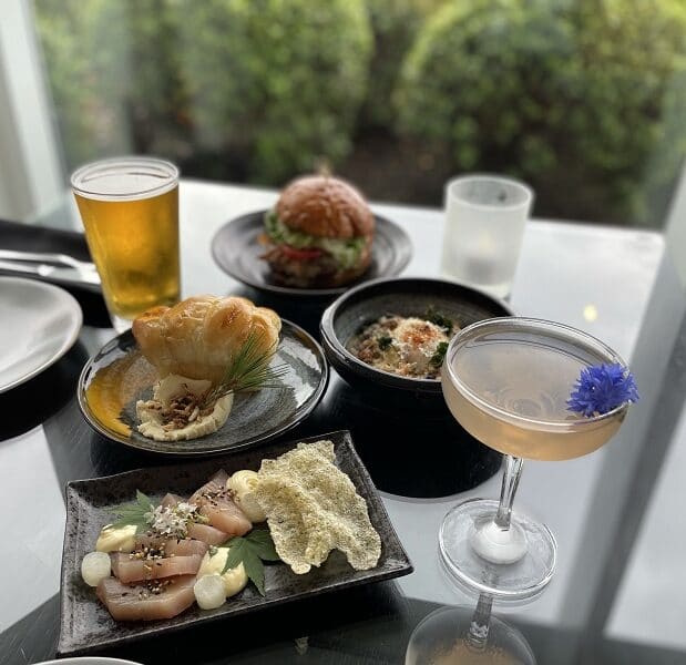 a selection of small plates dinner menu items on a table in aura restaurant