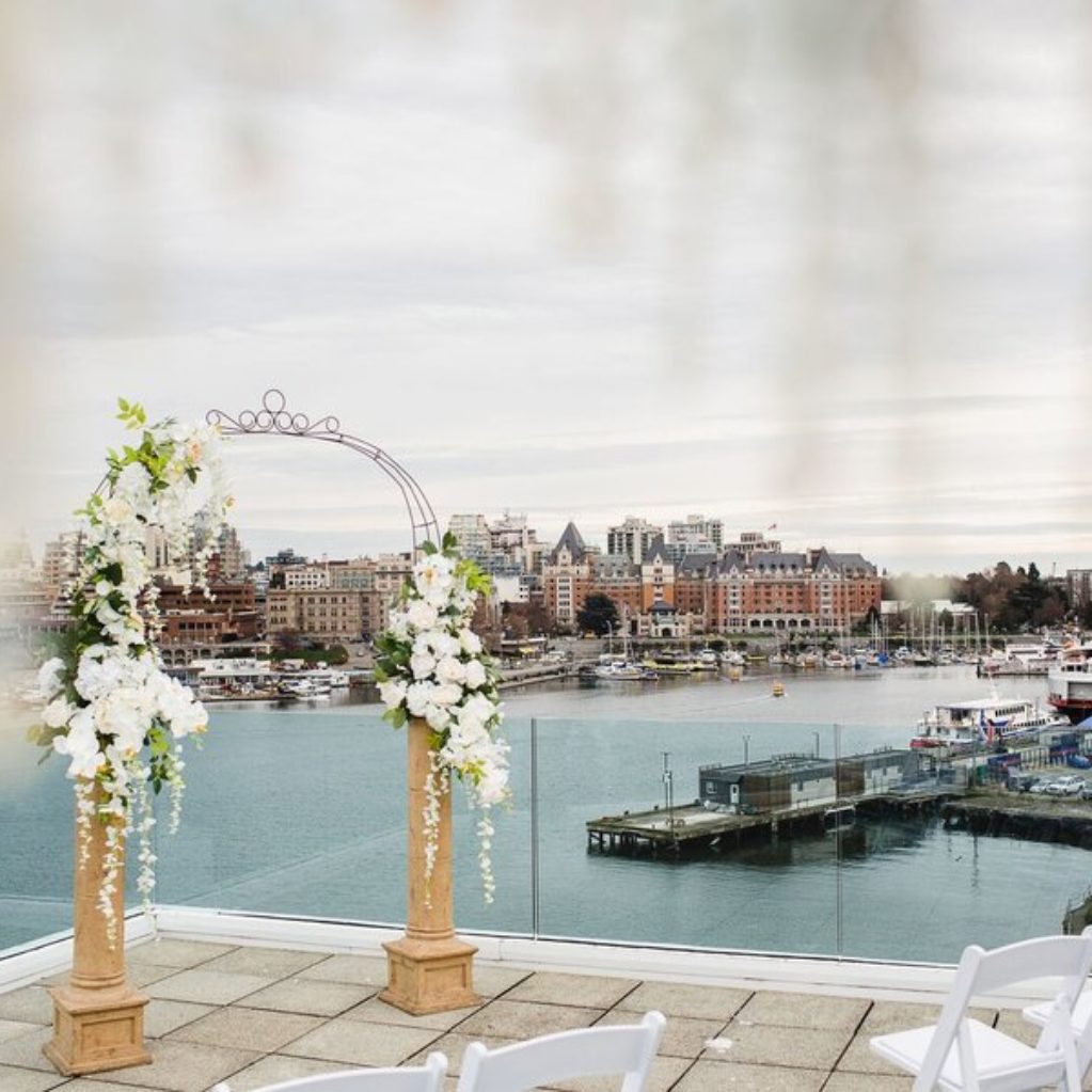 Outdoor penthouse wedding ceremony with floral arch