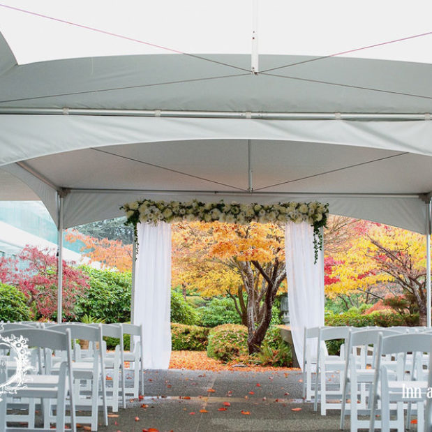 Outdoor fall wedding ceremony set-up under tents