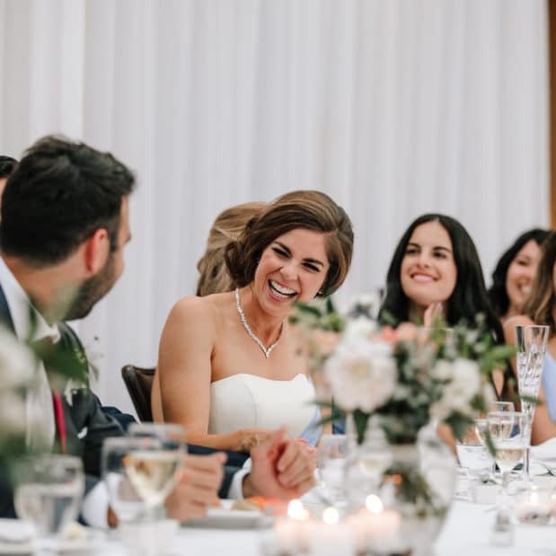 Bride laughing at wedding reception