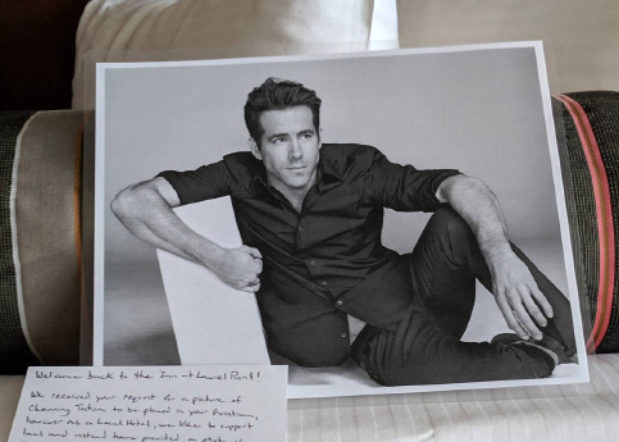 black and white photo of actor Ryan Reynolds on bed with handwritten note