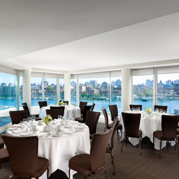 Inn at Laurel Point penthouse meeting room Rogers Suite set for dinner, views of Victoria's Inner Harbour