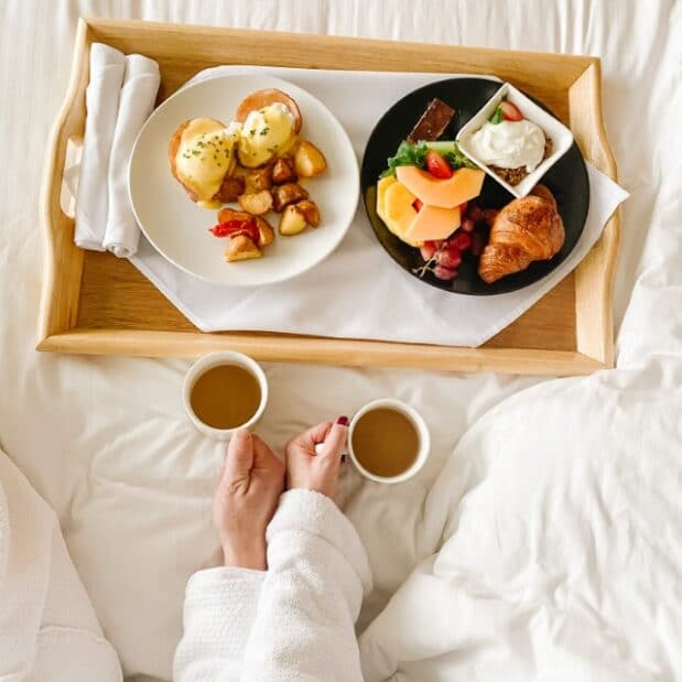 overhead shot of room service tray two arms with coffee