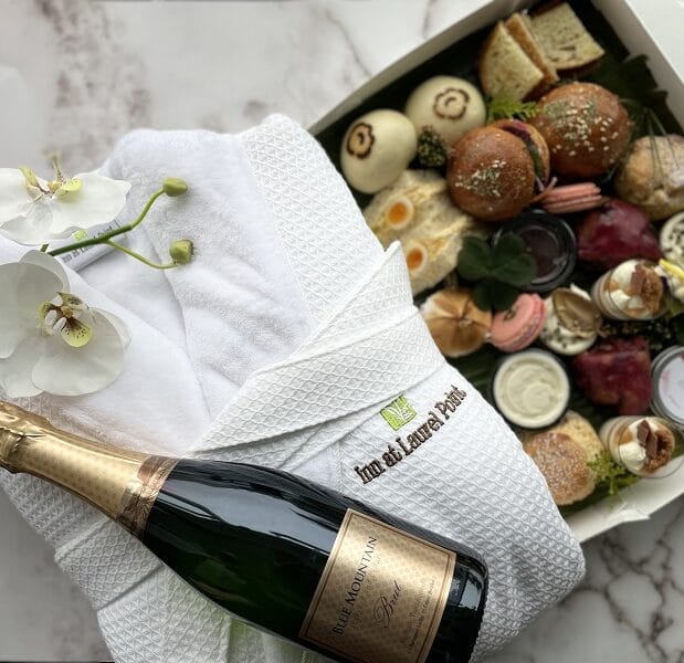 Tea for Two in a to go box, Inn at Laurel Point robe and bottle of Blue Mountain Brut