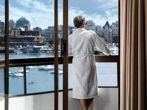 Laurel Wing Guestroom balcony with man in robe looking out