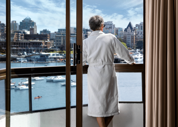 Laurel Wing Guestroom balcony with man in robe looking out