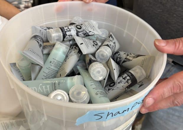 bucket of refilled shampoo bottles at soap for hope