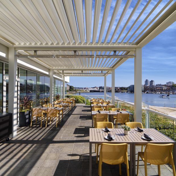 patio set on a sunny day with no people at Aura Waterfront Restaurant + Patio