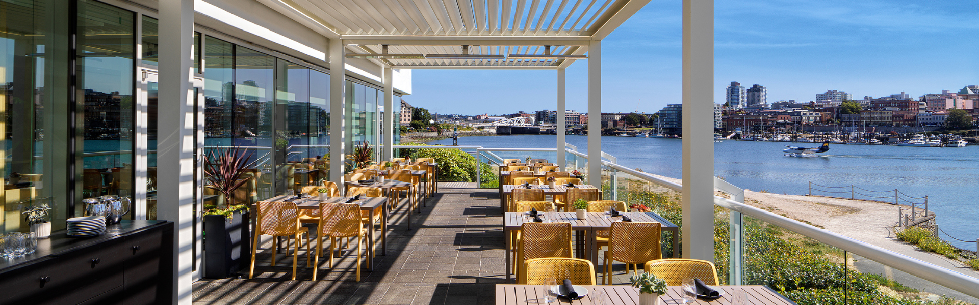 patio set on a sunny day with no people at Aura Waterfront Restaurant + Patio