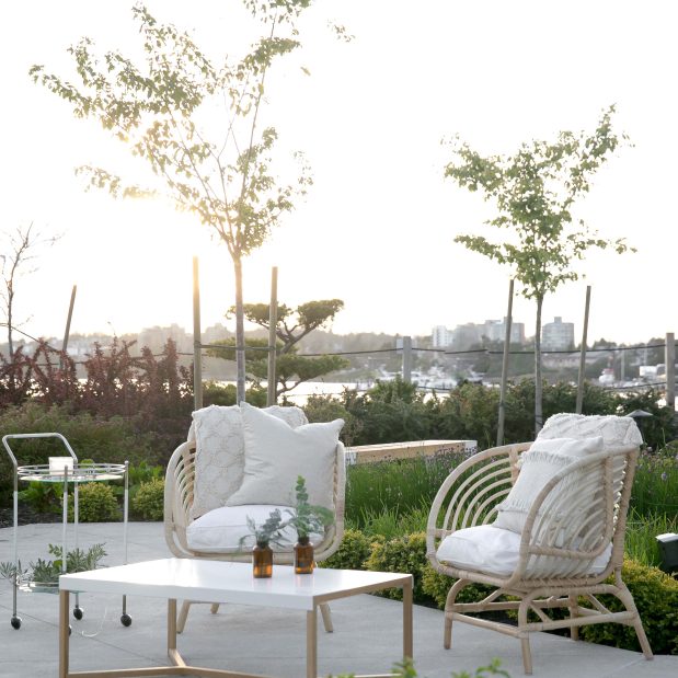wicker chairs and coffee table in the private gardens of Inn at Laurel Point
