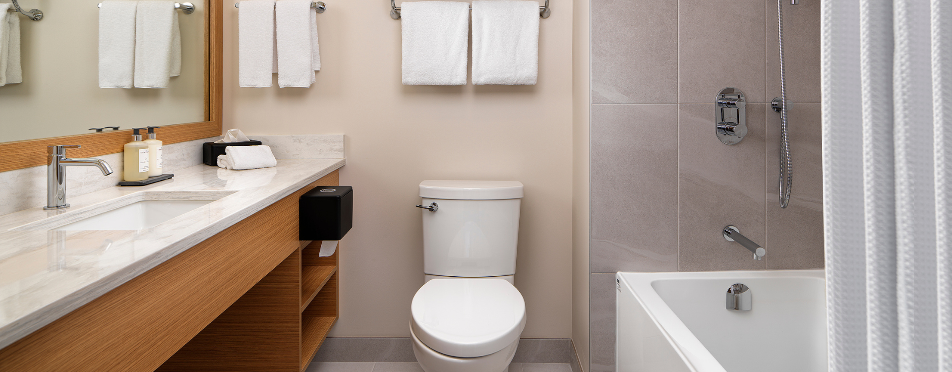 bathroom of Laurel Wing sunset guestrooms, bathtub shower, toilet and sink all visible