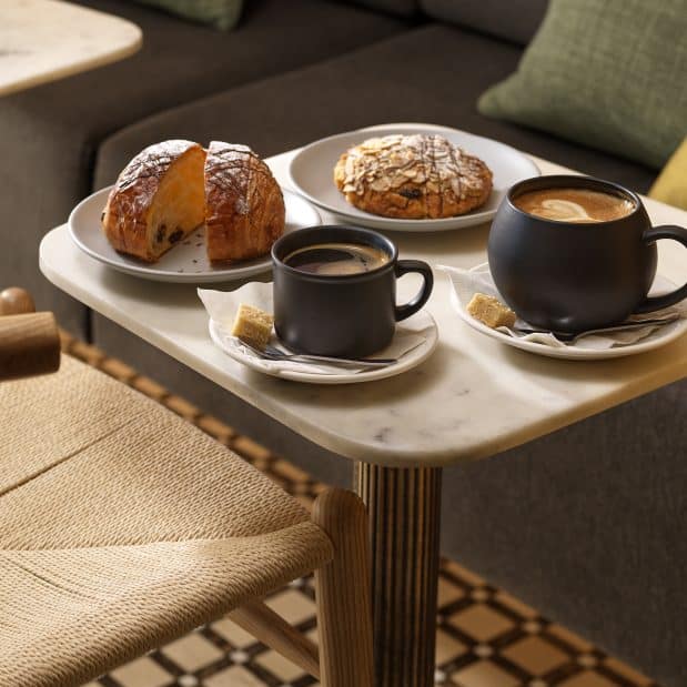 2 mugs and 2 croissants on a table in Duo Cafe Bakery