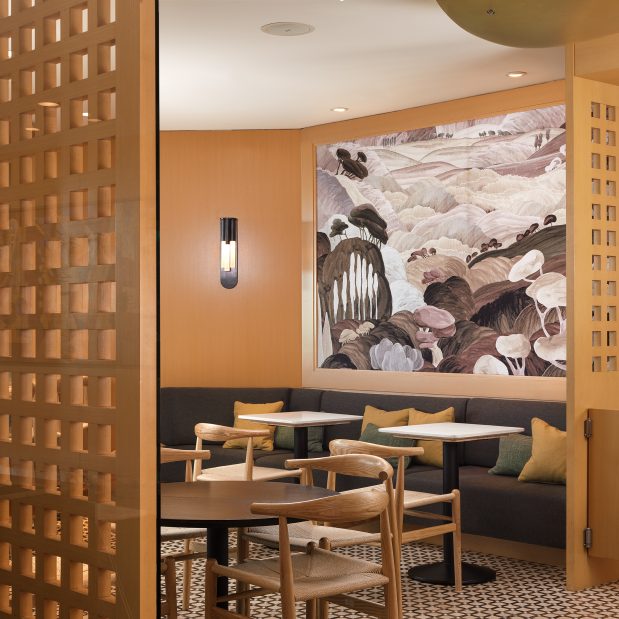 inside of Duo Cafe Bakery, mural and empty tables