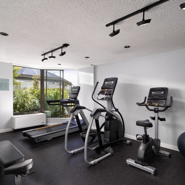 fitness studio at Inn at Laurel Point, 3 workout machines, water station, exercise balls, bench and tv in the room