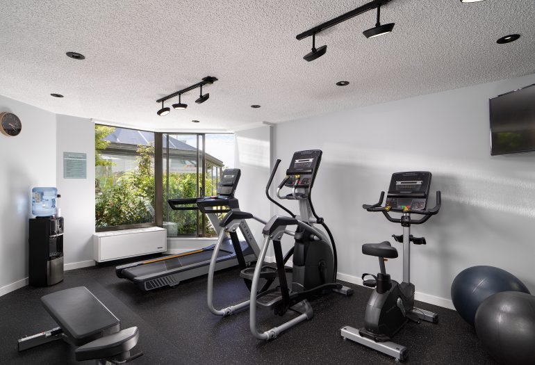 fitness studio at Inn at Laurel Point, 3 workout machines, water station, exercise balls, bench and tv in the room