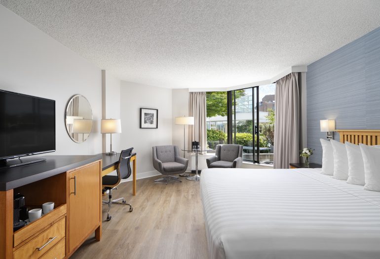 Laurel Wing King Guestroom at Inn at Laurel Point, looking out to private gardens with a ping pong table