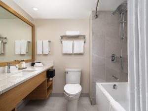 bathroom of Laurel Wing sunset guestrooms, bathtub shower, toilet and sink all visible