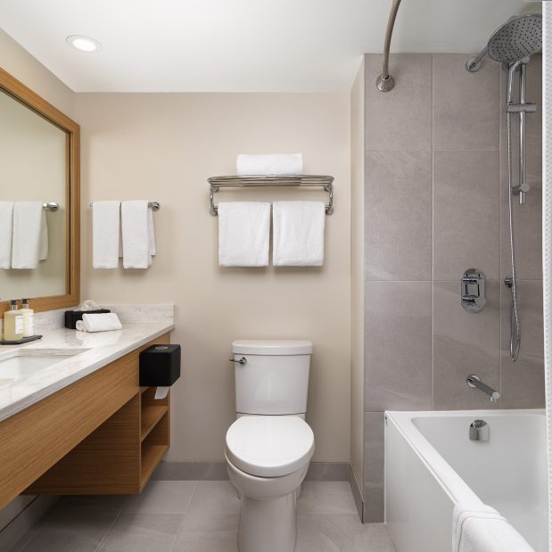 bathroom of Laurel Wing sunset guestrooms, bathtub shower, toilet and sink all visible